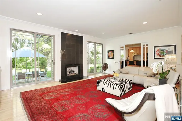 a bedroom with a bed and a large window with outer view