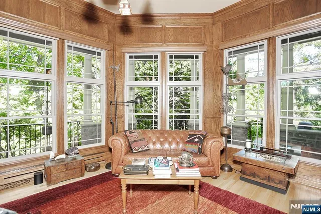 a living room with furniture and floor to ceiling windows