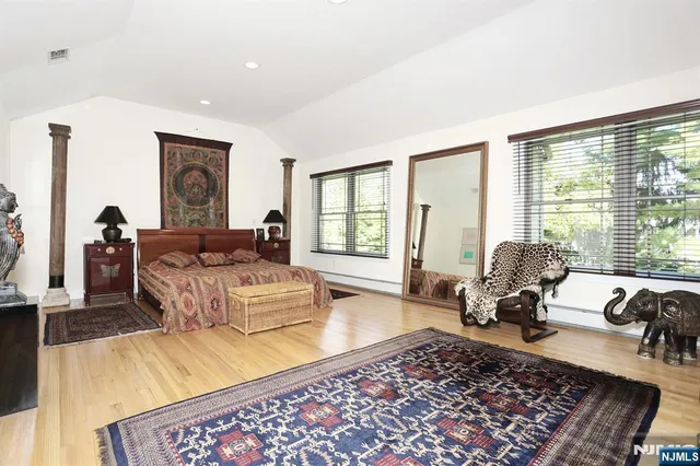 a living room with furniture large window and rug