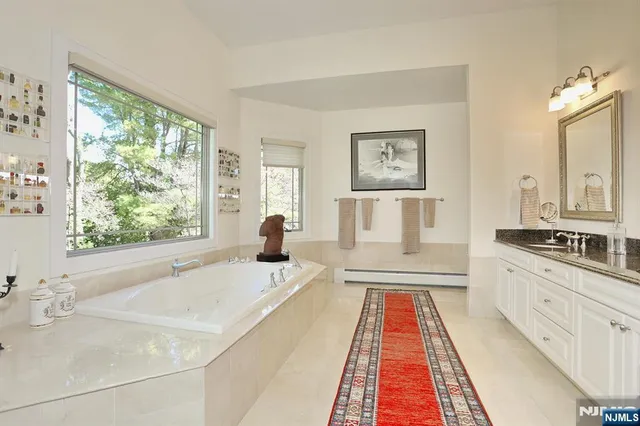 a spacious bedroom with a large bed and a window