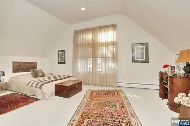 a bedroom with two beds and a window