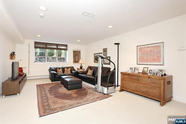a living room with furniture window and a flat screen tv