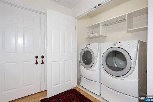 a view of a hallway with washer and dryer
