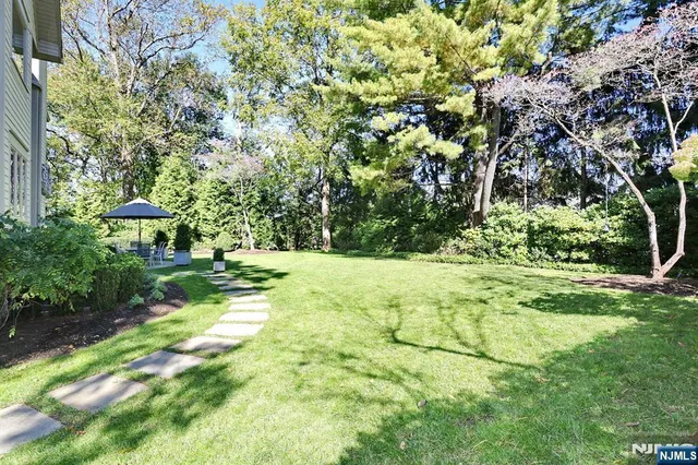 a view of backyard with swimming pool and patio