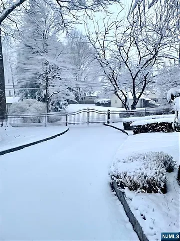 a view of a yard with wooden fence