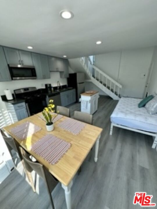 14 Mast Street Marina del Rey, CA 90292 - Photo 39 of 56 a kitchen with stainless steel appliances wooden floor dining table and chairs