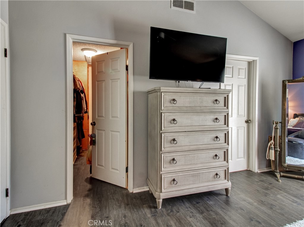 1669 Erin Avenue Upland, CA 91784 - Photo 17 of 27 a view of bedroom with wooden floor and flat screen tv