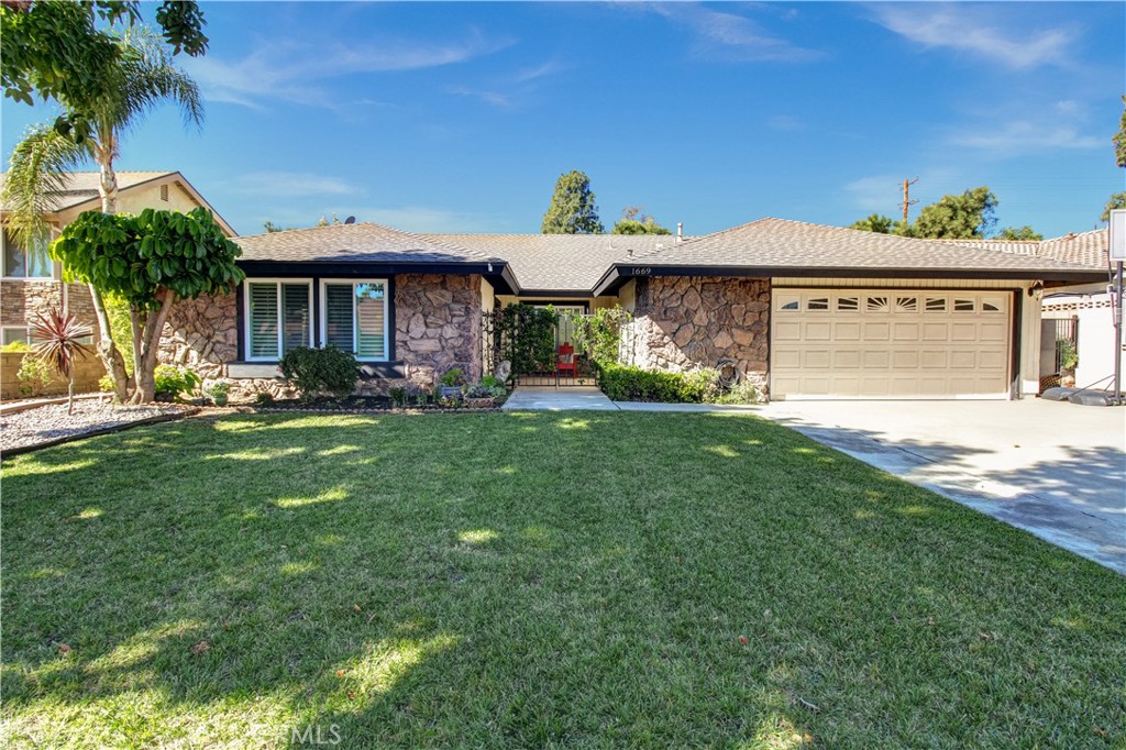 1669 Erin Avenue Upland, CA 91784 - Photo 20 of 27 a front view of a house with a yard and palm trees