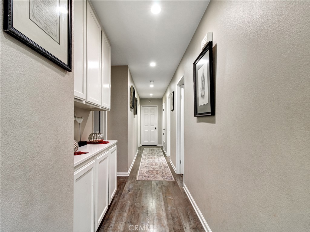 1669 Erin Avenue Upland, CA 91784 - Photo 8 of 27 a hallway with white cabinets and white appliances