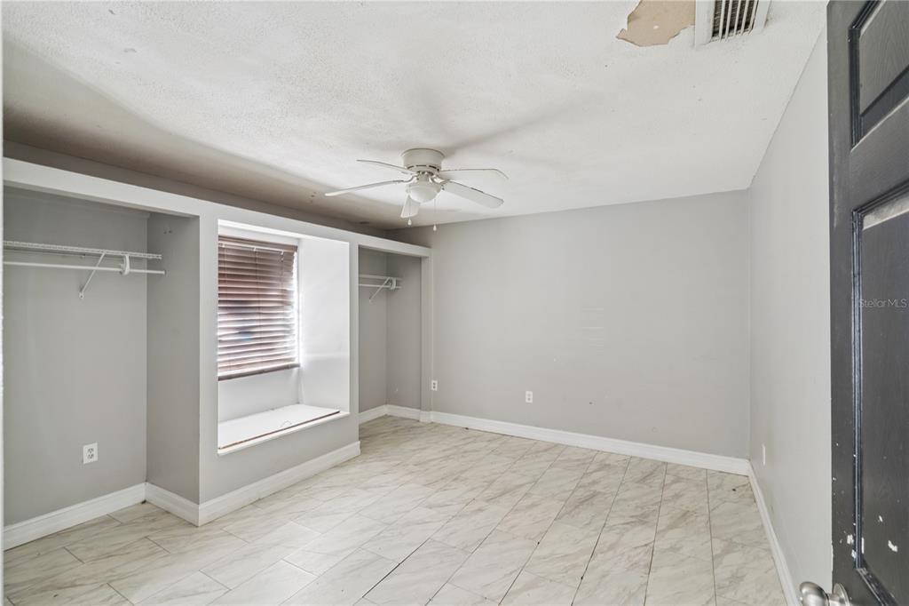 434 Diamond Acres Road Davenport, FL 33837 - Photo 11 of 20 an empty room with windows and fan