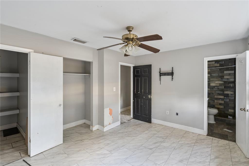 434 Diamond Acres Road Davenport, FL 33837 - Photo 12 of 20 a view of a big room with closet and chandelier fan