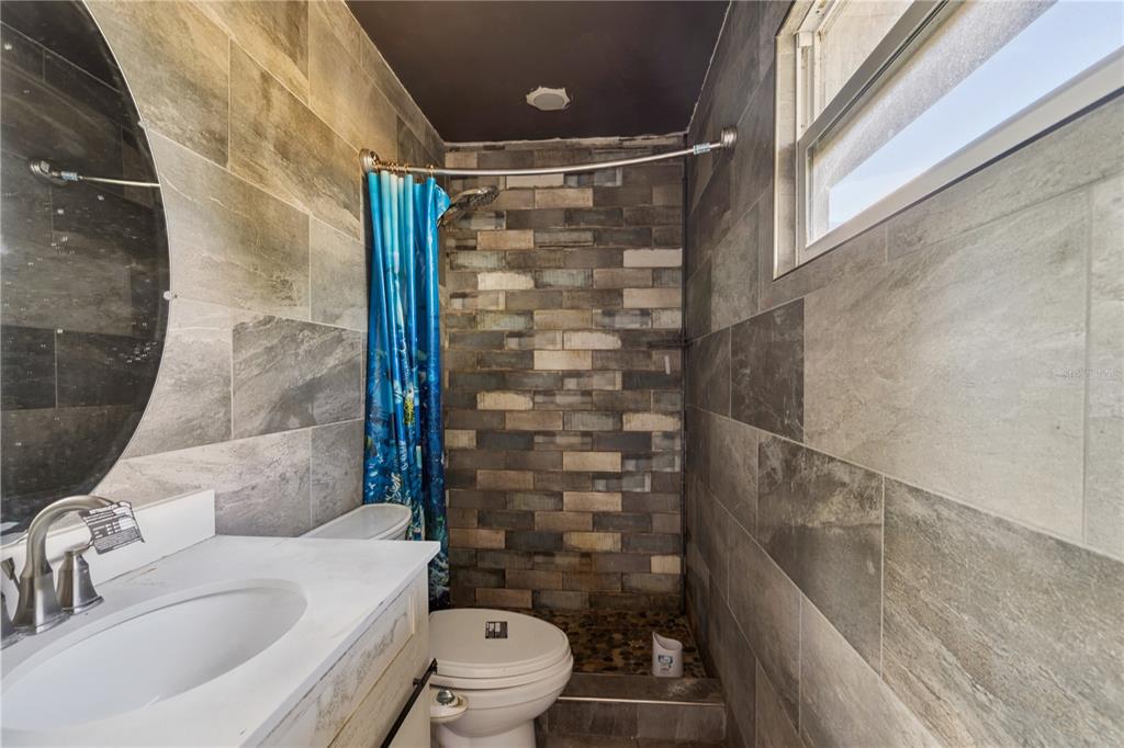 434 Diamond Acres Road Davenport, FL 33837 - Photo 13 of 20 a bathroom with a shower and a toilet