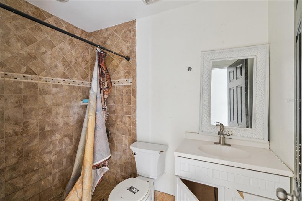 434 Diamond Acres Road Davenport, FL 33837 - Photo 14 of 20 a bathroom with a sink toilet and shower