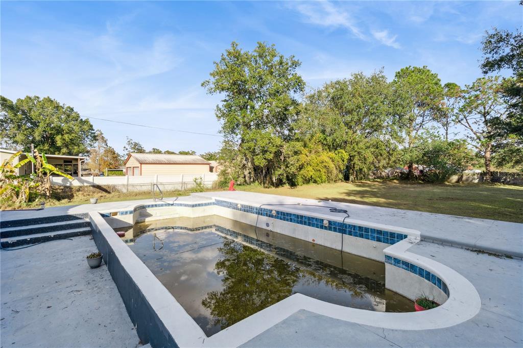 434 Diamond Acres Road Davenport, FL 33837 - Photo 19 of 20 a view of a swimming pool with a yard and outdoor seating