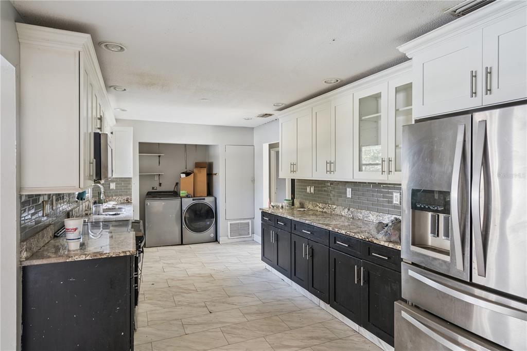 434 Diamond Acres Road Davenport, FL 33837 - Photo 6 of 20 a kitchen with stainless steel appliances granite countertop a refrigerator a stove and a sink