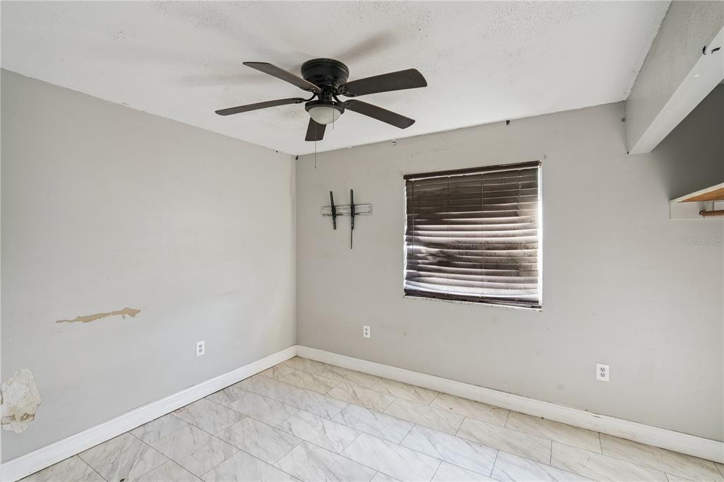 434 Diamond Acres Road Davenport, FL 33837 - Photo 10 of 20 a view of a big room with a ceiling fan and windows
