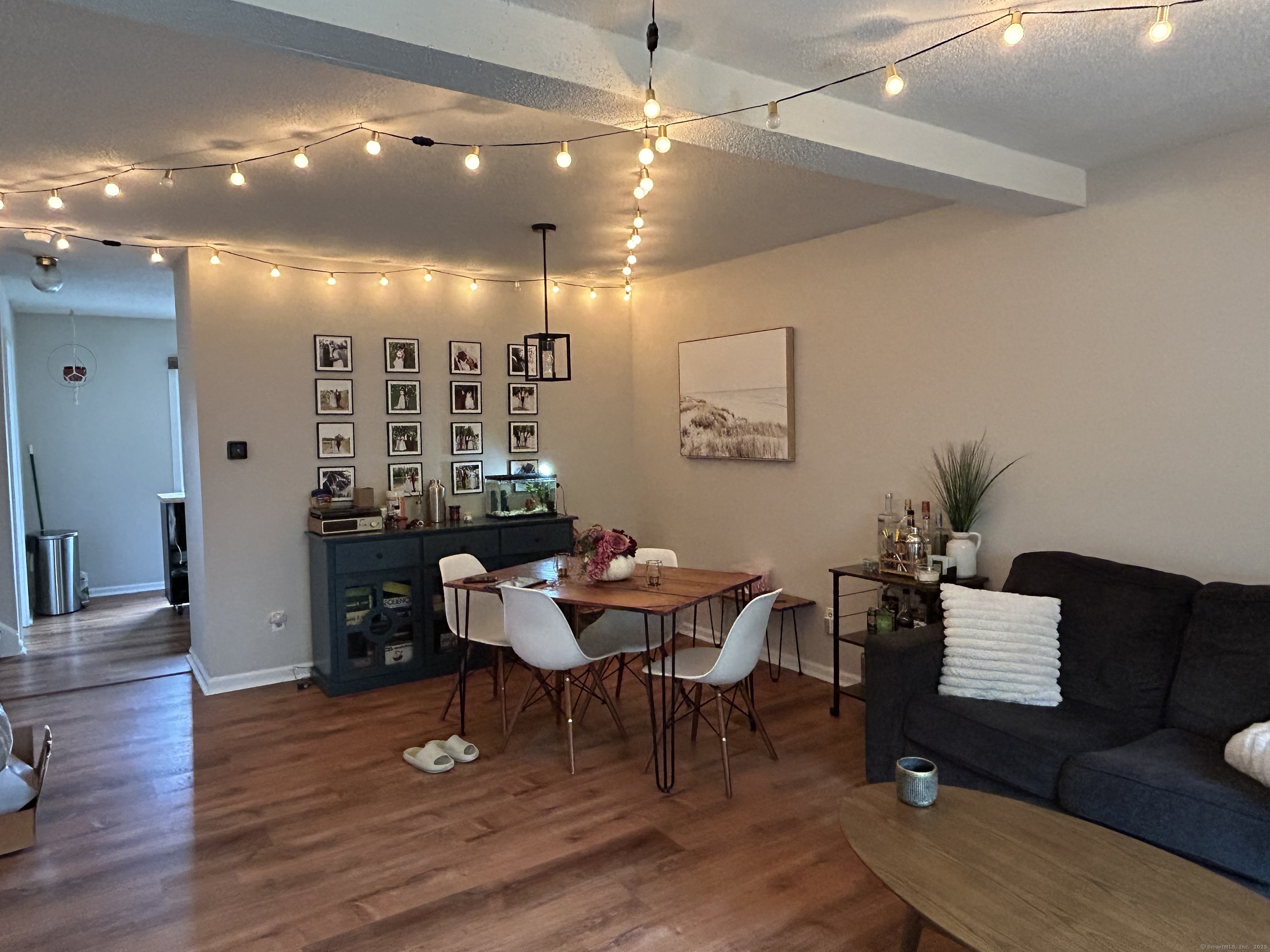 489 Wolcott Street, Unit 85 Bristol, CT 06010 - Photo 6 of 17 a view of a livingroom with furniture and a dining table with wooden floor