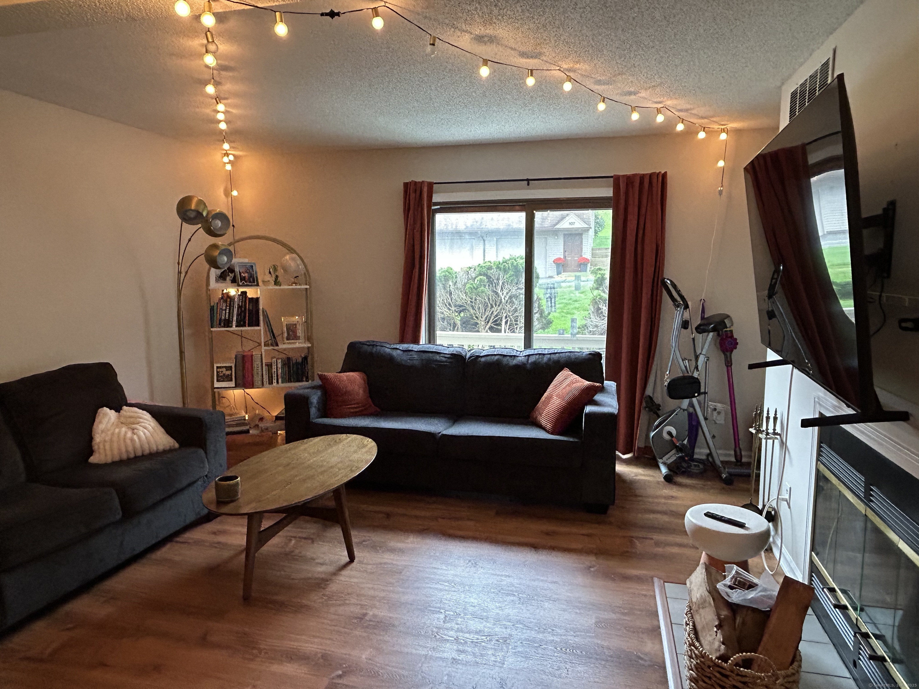 489 Wolcott Street, Unit 85 Bristol, CT 06010 - Photo 7 of 17 a living room with furniture a window and a flat screen tv