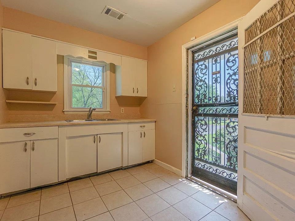 2061 Pendleton Street Memphis, TN 38114 - Photo 5 of 9 a kitchen with granite countertop a sink and a window