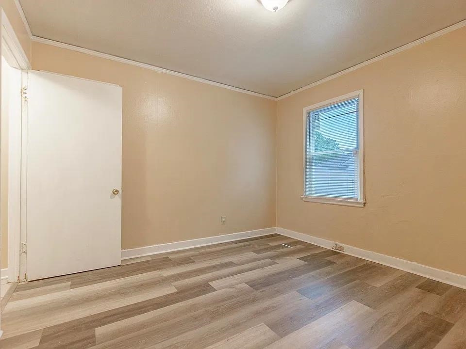 2061 Pendleton Street Memphis, TN 38114 - Photo 8 of 9 a view of a small space with wooden floor and a window