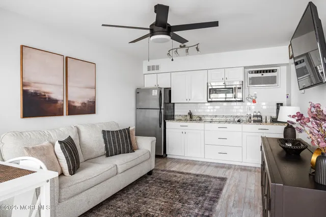a living room with furniture and kitchen view