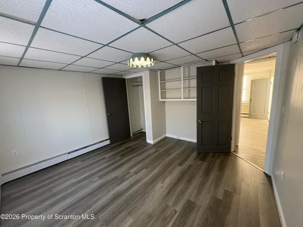 a view of hallway with wooden floor