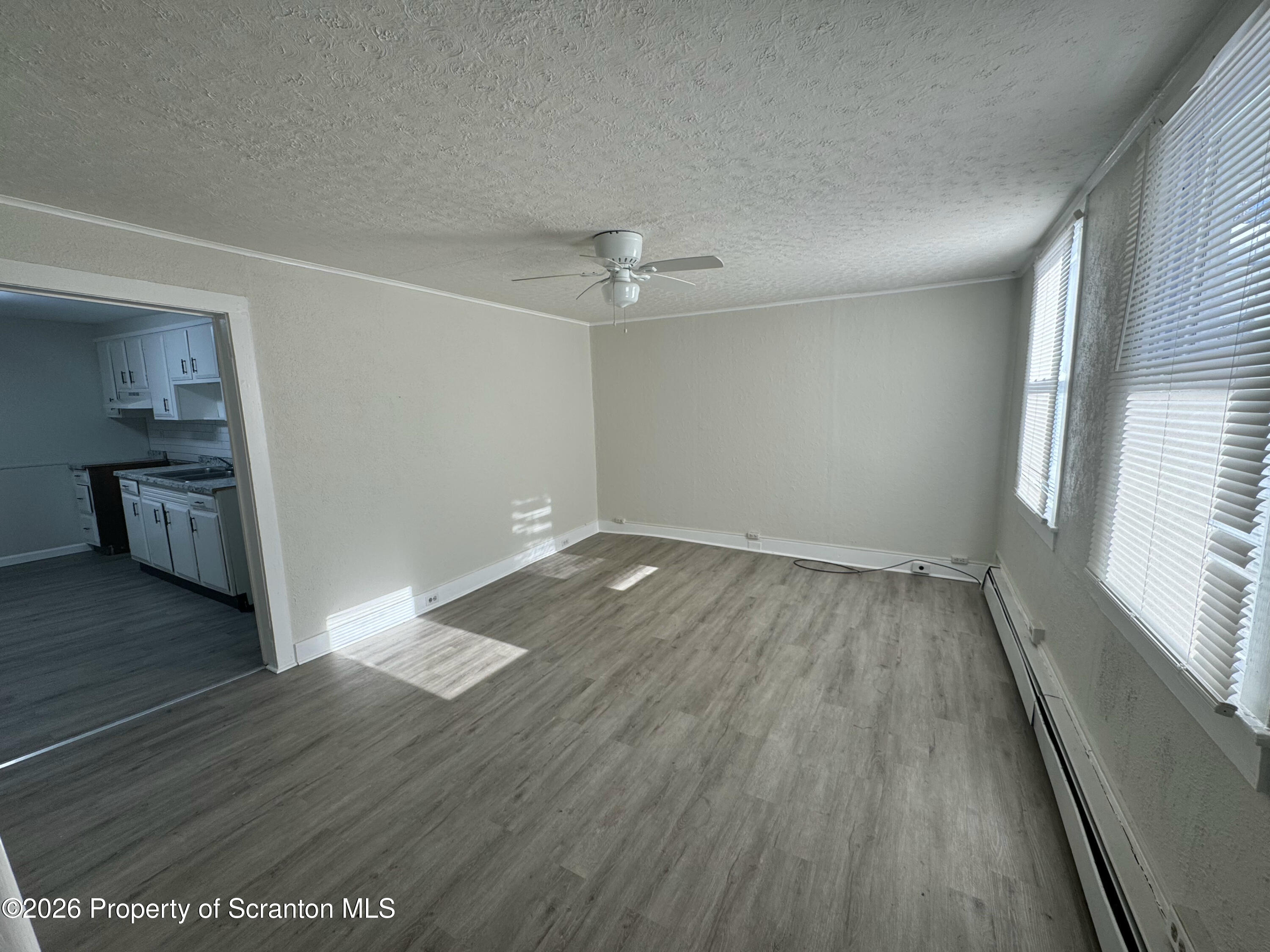 513 Oak Street Old Forge, PA 18518 - Photo 2 of 14 wooden floor in an empty room with a window