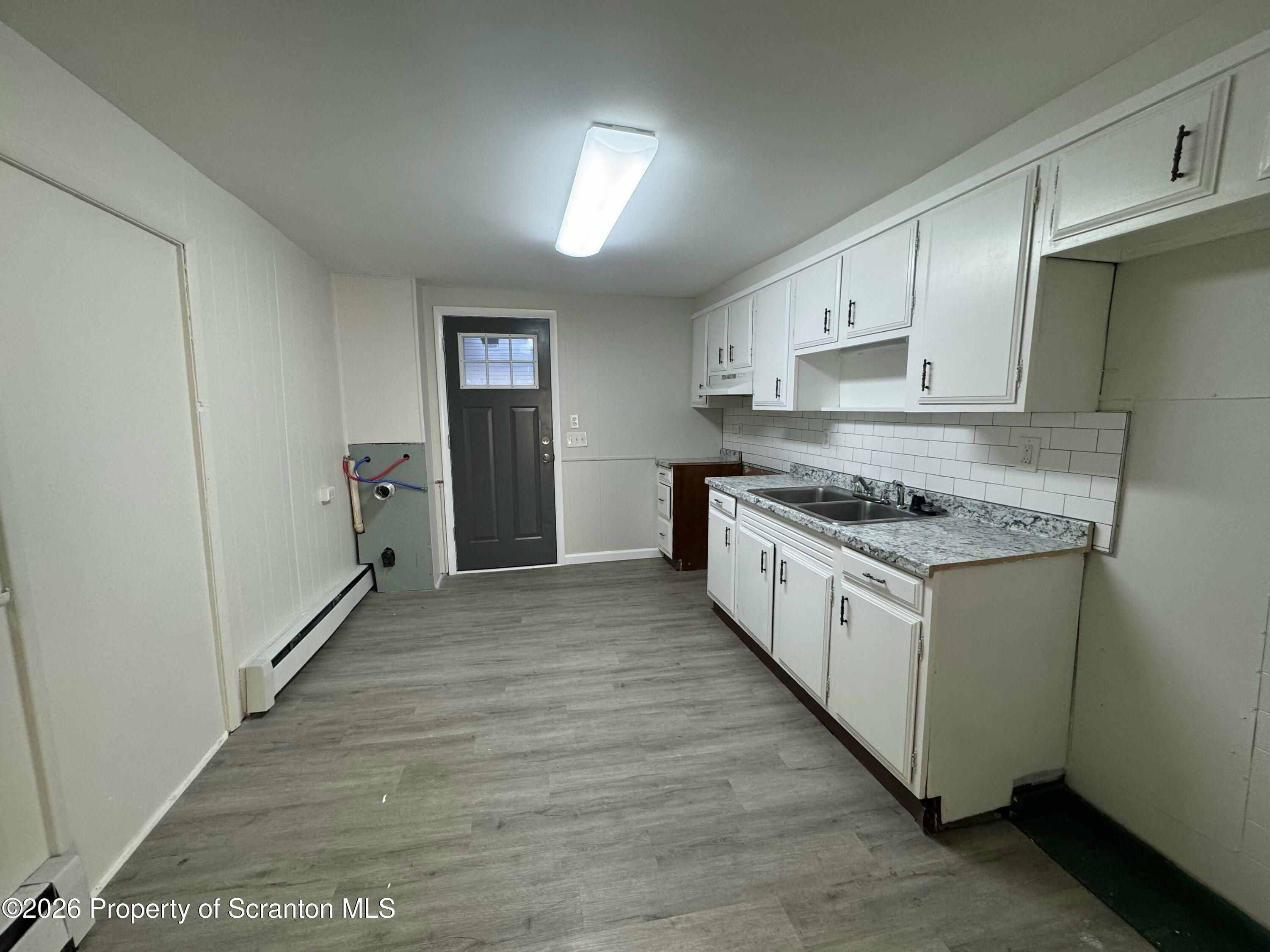 513 Oak Street Old Forge, PA 18518 - Photo 3 of 14 a kitchen with stainless steel appliances granite countertop a stove and a sink