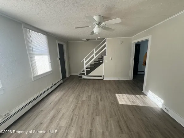 wooden floor in an empty room with a window