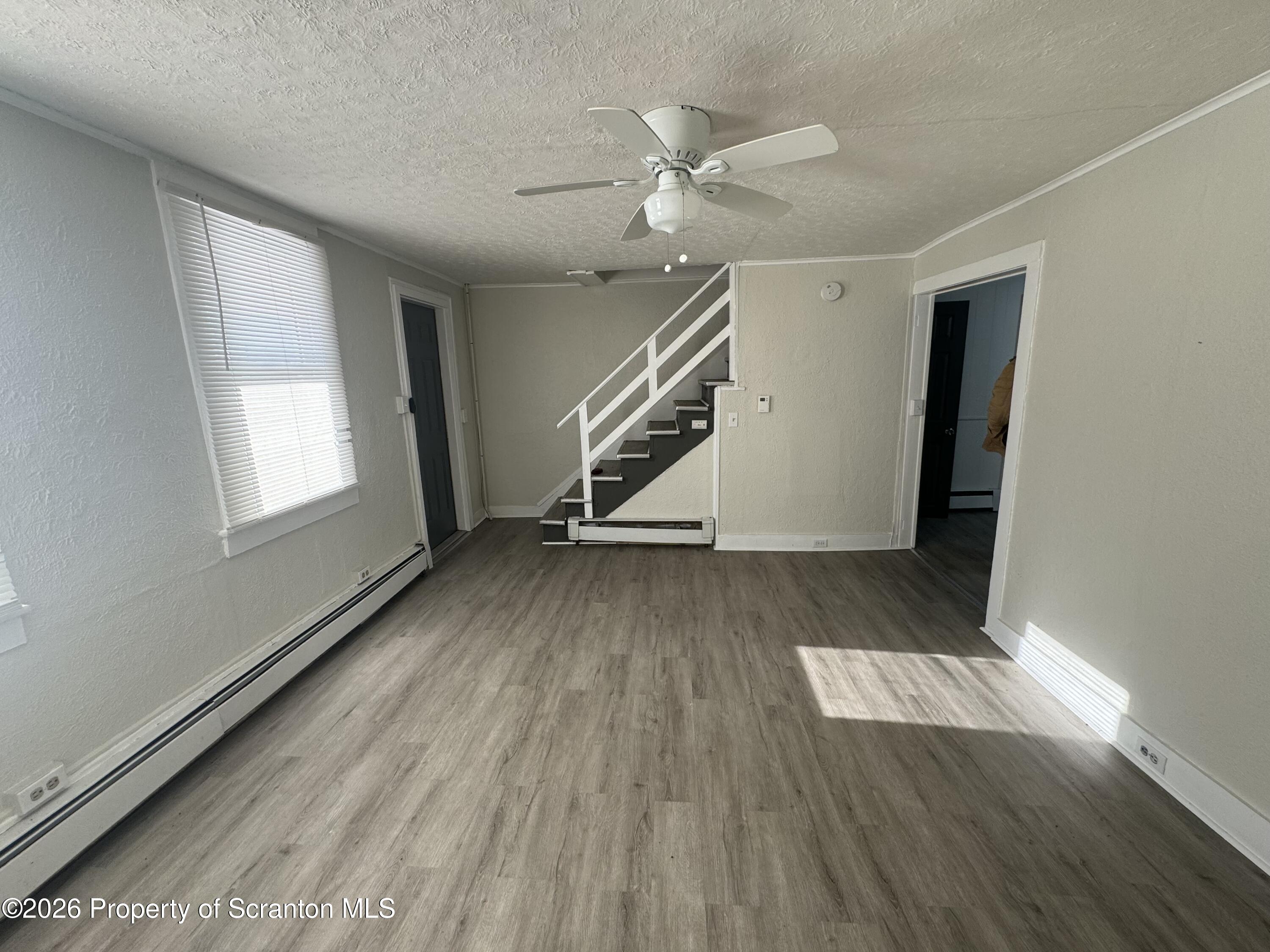 513 Oak Street Old Forge, PA 18518 - Photo 6 of 14 wooden floor in an empty room with a window