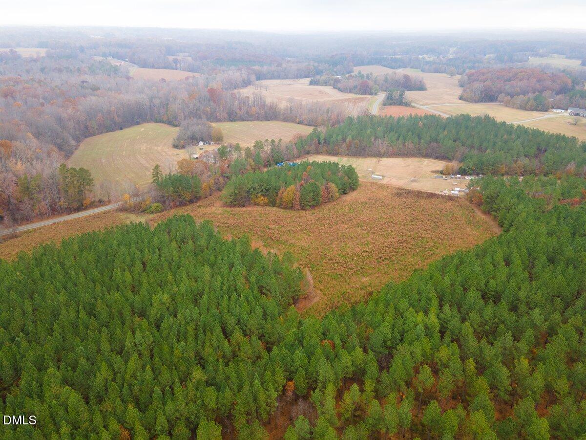 5 Old Allensville Road Roxboro, NC 27574 - Photo 2 of 6 a view of a lake in middle of the green field