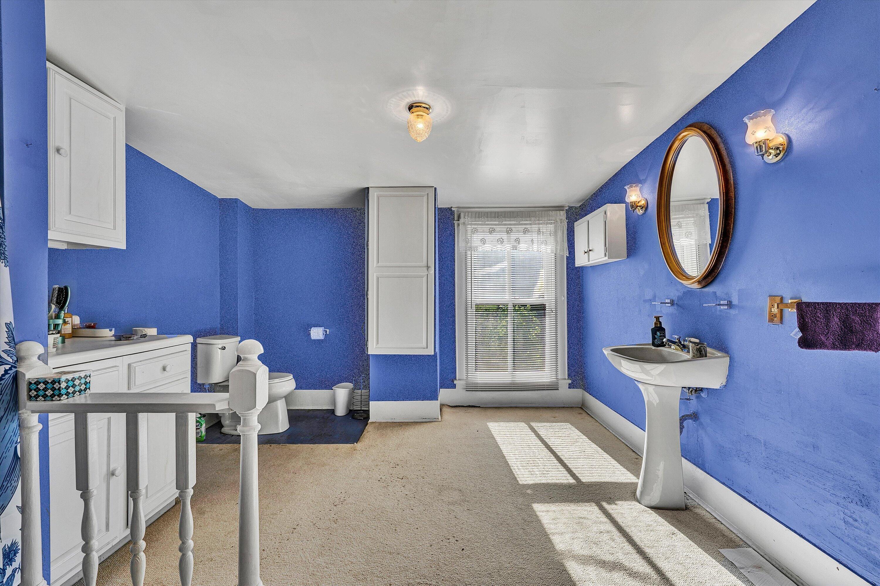 624 South Maple Street Vinton, VA 24179 - Photo 25 of 40 a bathroom with a sink mirror and a window