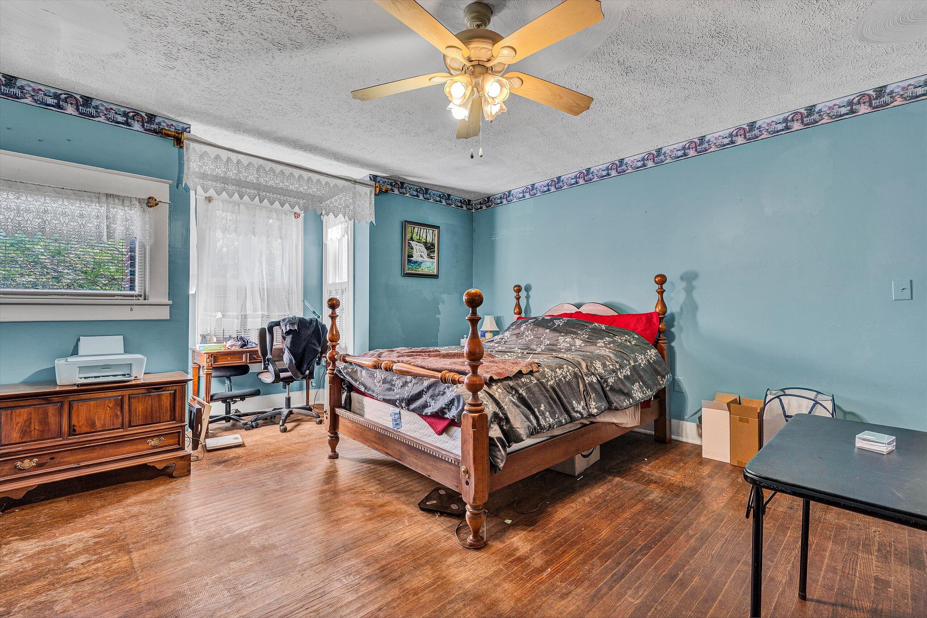 624 South Maple Street Vinton, VA 24179 - Photo 9 of 40 a bed room with a bed and a chandelier