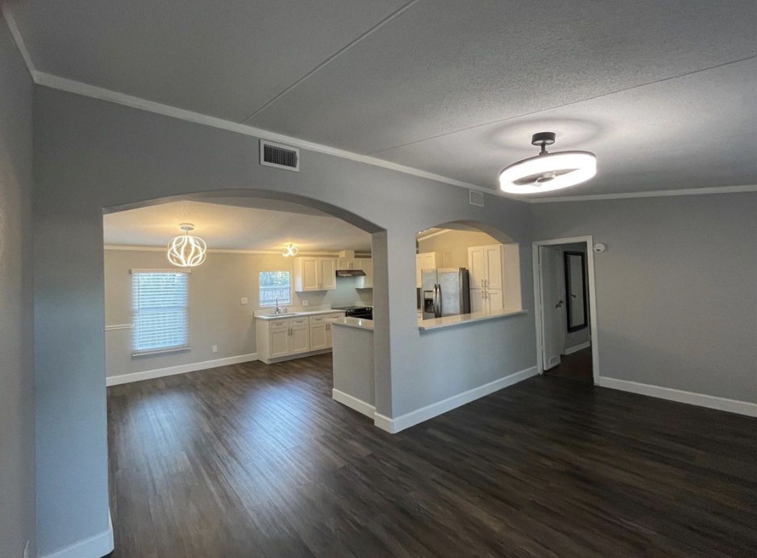 a view of a room with wooden floors and a window