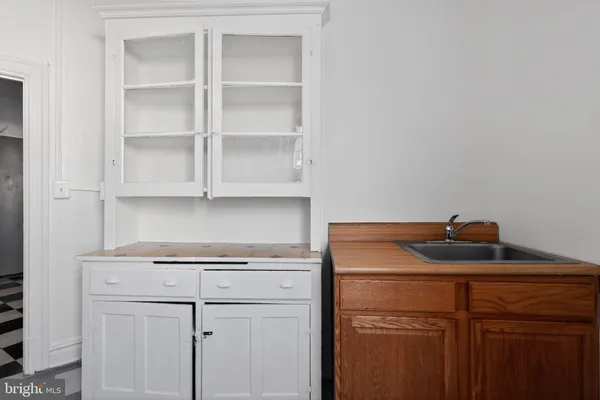 a close view of a sink and cabinets in a room