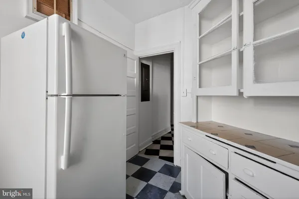 a white refrigerator freezer sitting inside of a kitchen
