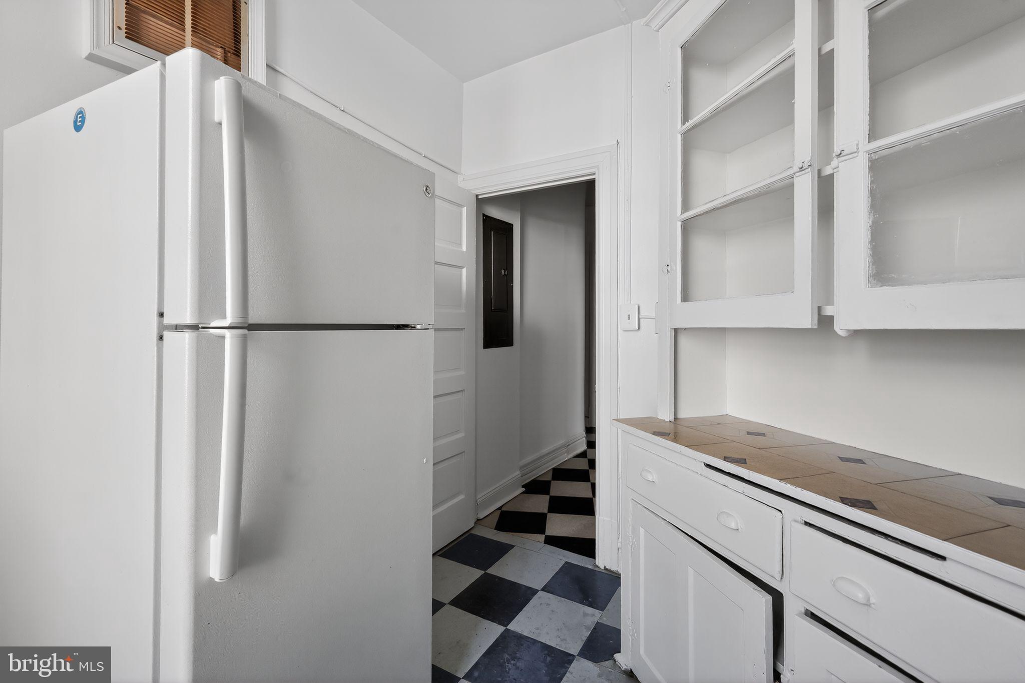 2854 Connecticut Avenue Northwest, Unit 32 Washington, DC 20008 - Photo 10 of 12 a white refrigerator freezer sitting inside of a kitchen
