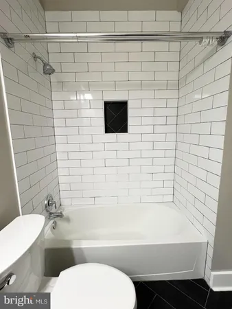 a bathroom with a toilet a sink and bathtub