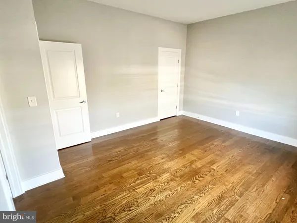an empty room with wooden floor