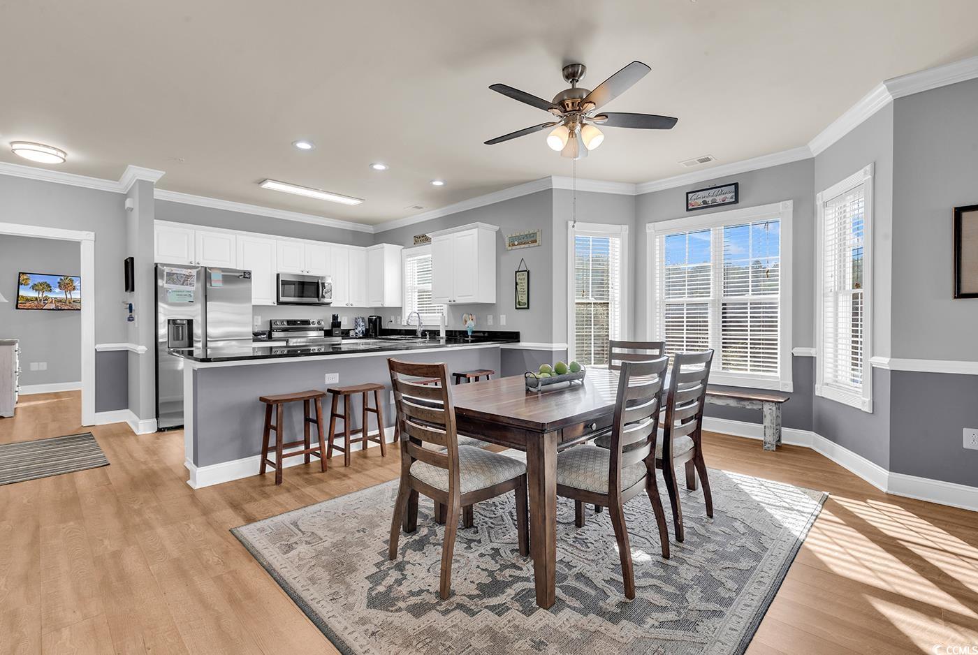 4829 Luster Leaf Circle, Unit 301 Myrtle Beach, SC 29577 - Photo 10 of 34 Dining area with ornamental molding, recessed lighting, light wood-style flooring, and ceiling fan