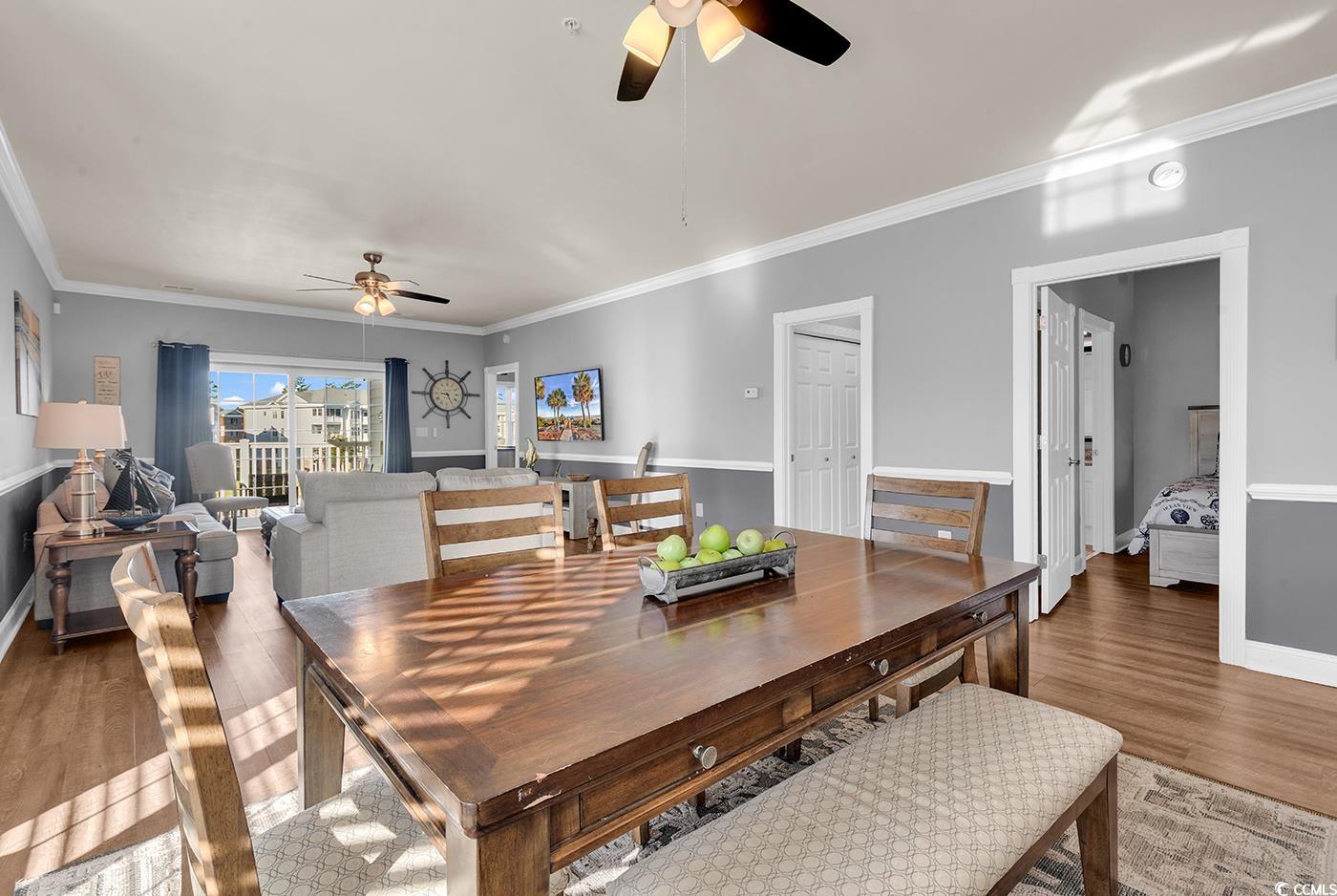 4829 Luster Leaf Circle, Unit 301 Myrtle Beach, SC 29577 - Photo 11 of 34 Dining area with ornamental molding, ceiling fan, and light wood-style floors
