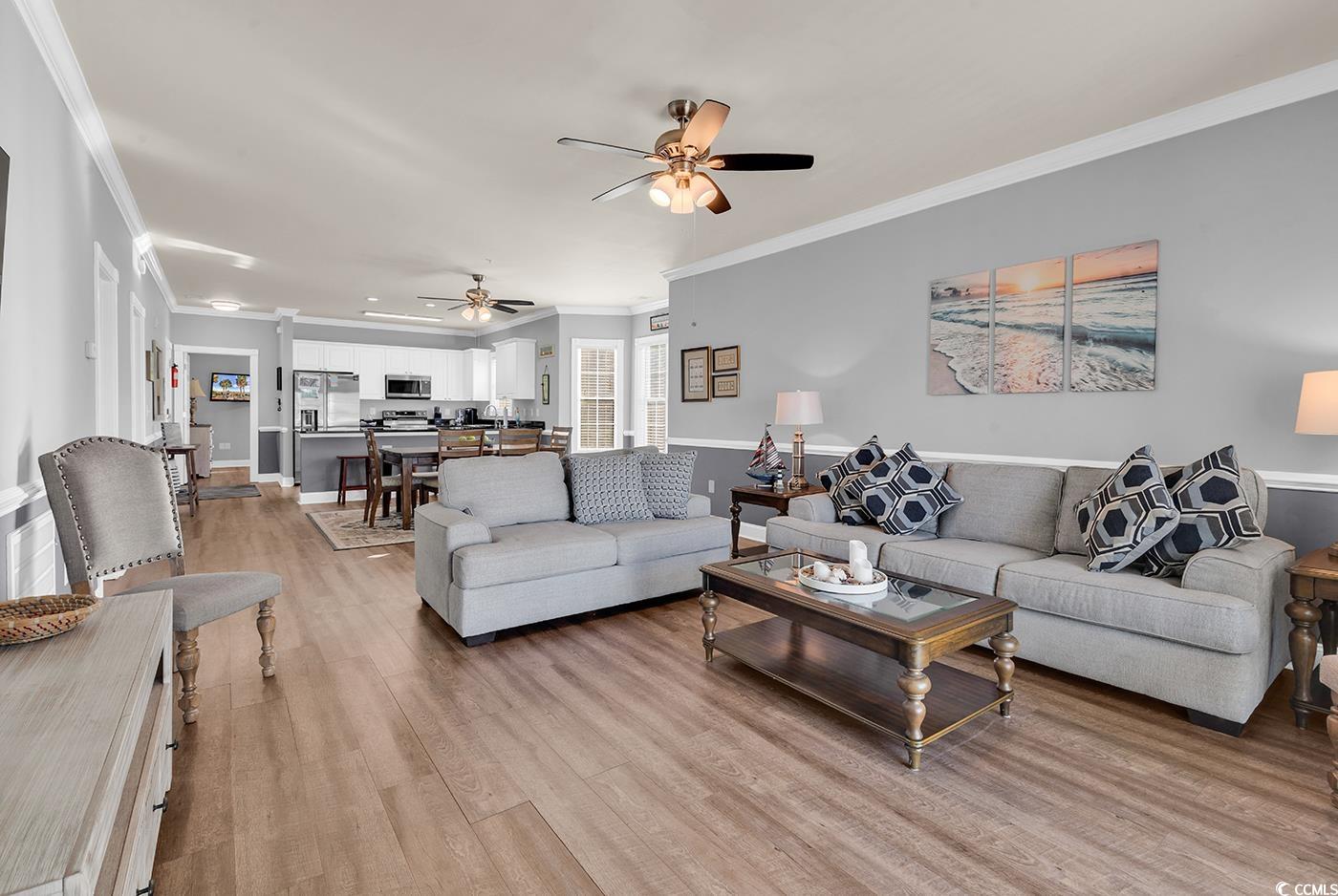 4829 Luster Leaf Circle, Unit 301 Myrtle Beach, SC 29577 - Photo 14 of 34 Living room featuring ornamental molding, light wood-style floors, and ceiling fan