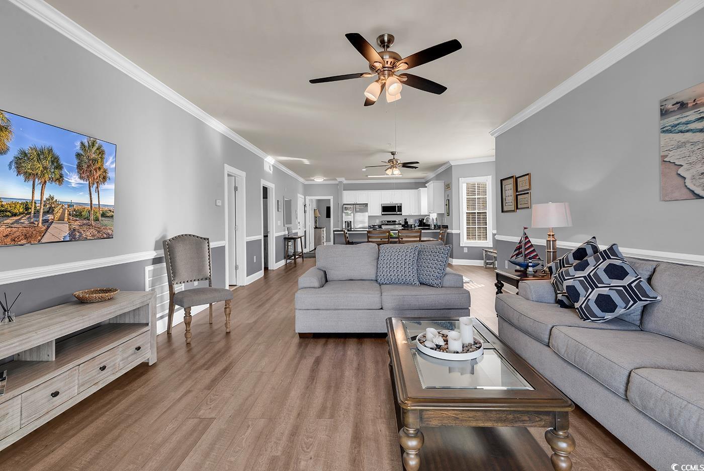 4829 Luster Leaf Circle, Unit 301 Myrtle Beach, SC 29577 - Photo 15 of 34 Living room with crown molding, wood finished floors, and ceiling fan