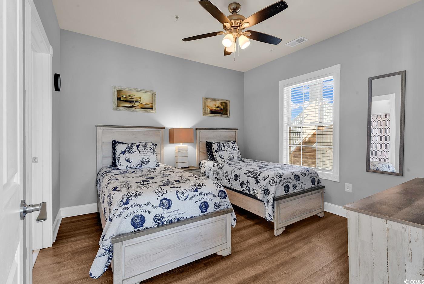 4829 Luster Leaf Circle, Unit 301 Myrtle Beach, SC 29577 - Photo 19 of 34 Bedroom with wood finished floors and a ceiling fan