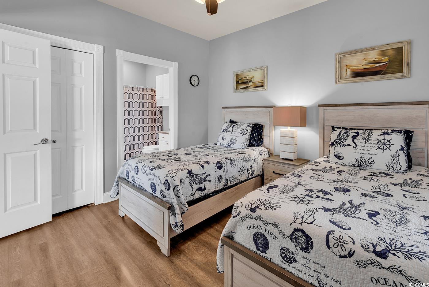 4829 Luster Leaf Circle, Unit 301 Myrtle Beach, SC 29577 - Photo 21 of 34 Bedroom with light wood-style flooring and ceiling fan