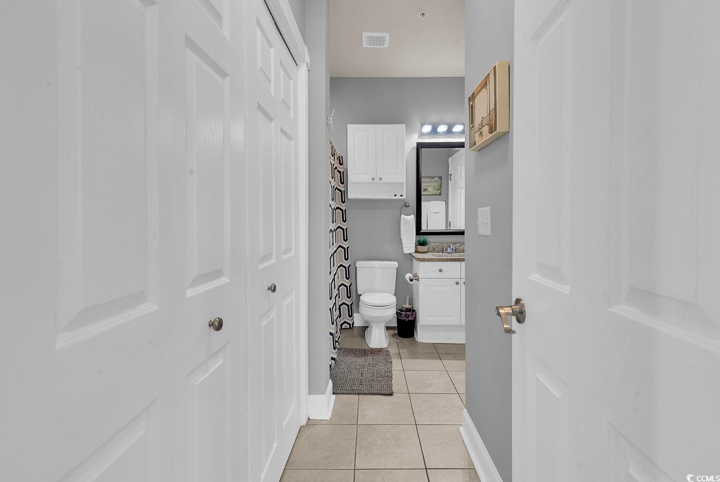4829 Luster Leaf Circle, Unit 301 Myrtle Beach, SC 29577 - Photo 23 of 34 Bathroom featuring light tile patterned floors and vanity