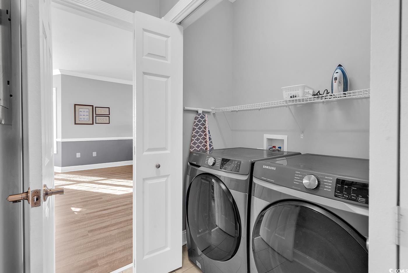 4829 Luster Leaf Circle, Unit 301 Myrtle Beach, SC 29577 - Photo 25 of 34 Laundry area with washing machine and dryer and light wood-style floors