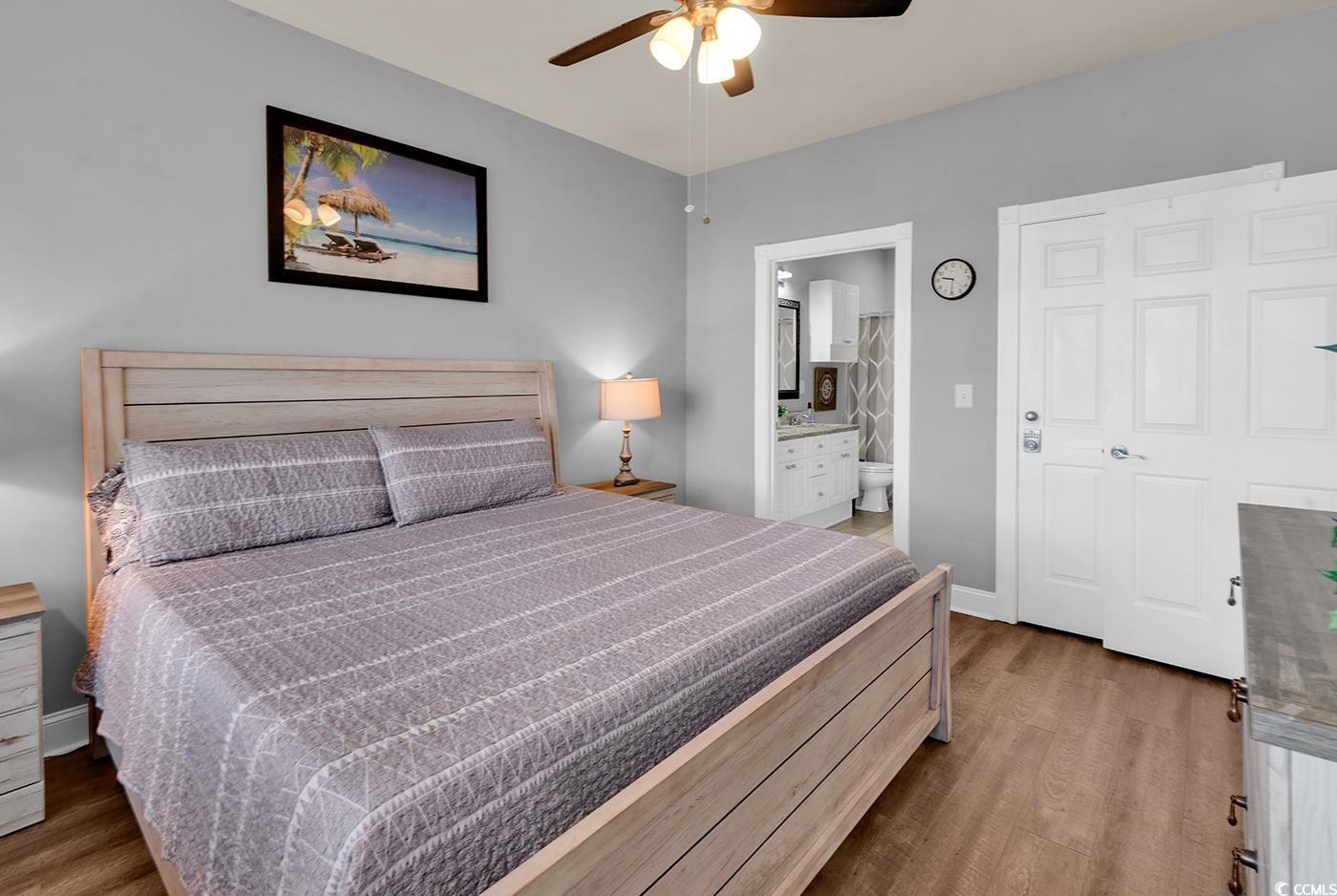 4829 Luster Leaf Circle, Unit 301 Myrtle Beach, SC 29577 - Photo 27 of 34 Bedroom featuring dark wood-type flooring, connected bathroom, and ceiling fan