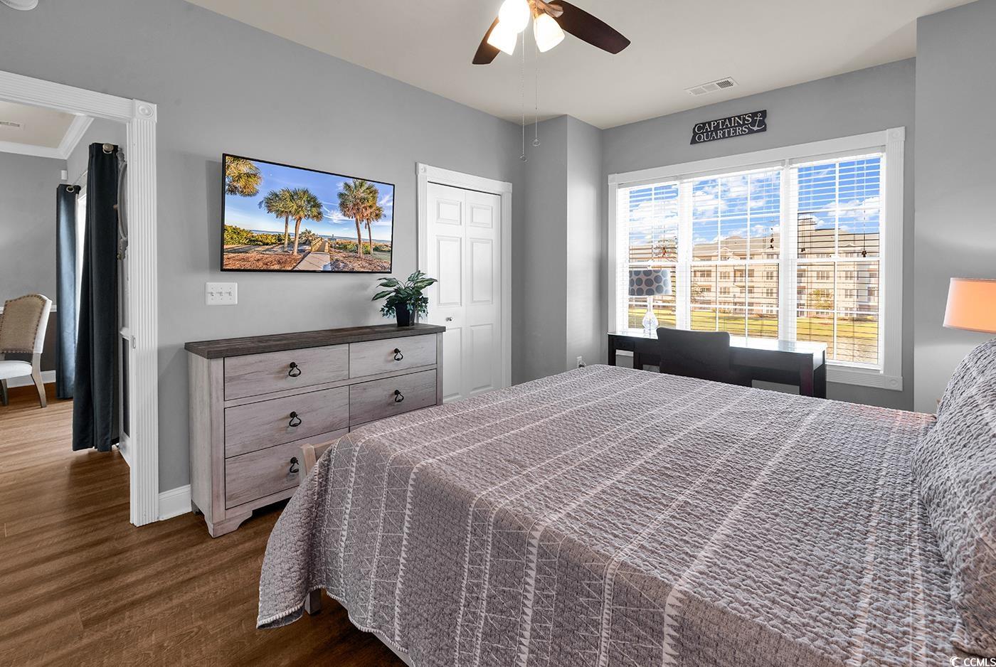 4829 Luster Leaf Circle, Unit 301 Myrtle Beach, SC 29577 - Photo 28 of 34 Bedroom with dark wood-style flooring, a ceiling fan, and crown molding