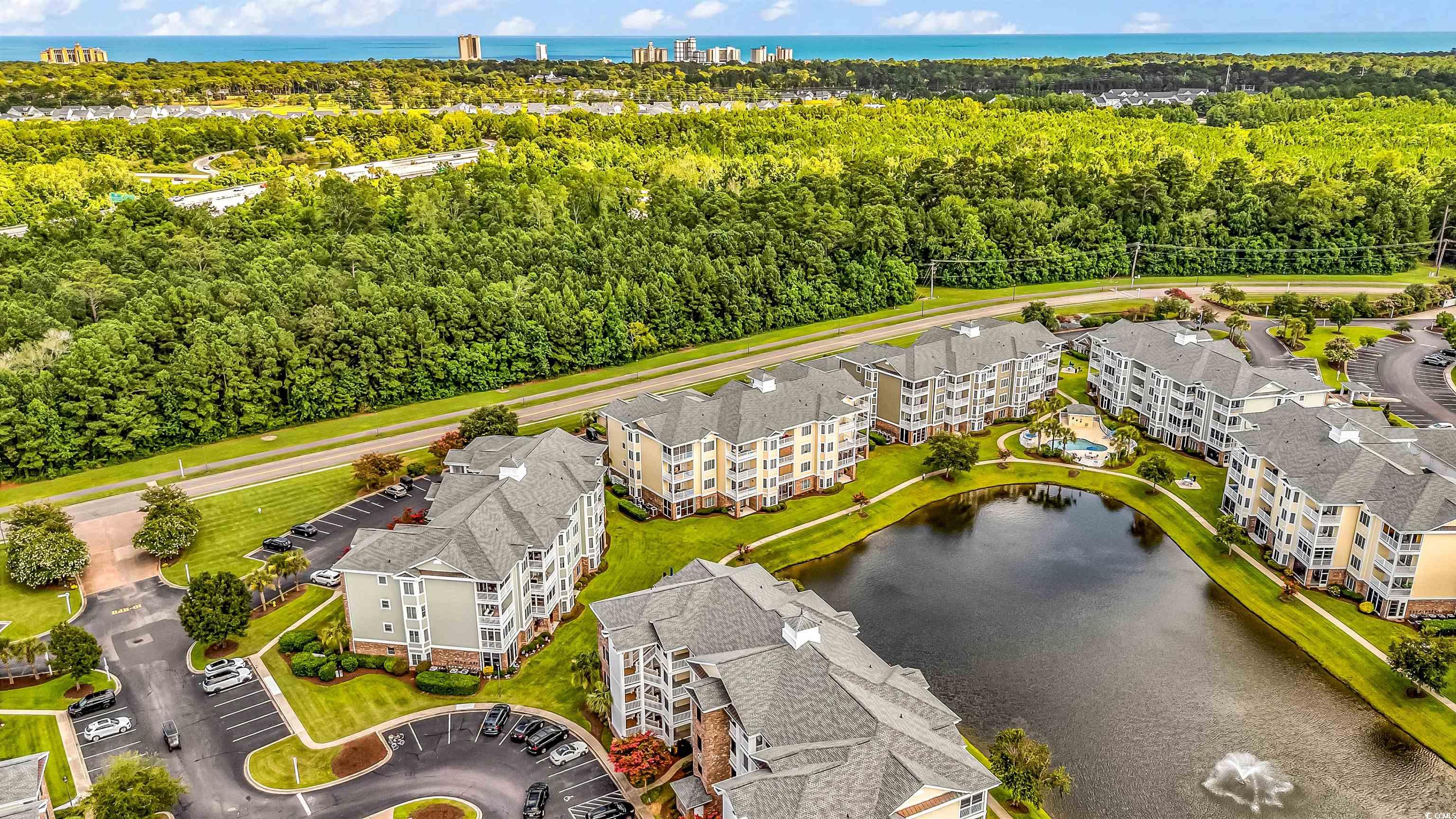 4829 Luster Leaf Circle, Unit 301 Myrtle Beach, SC 29577 - Photo 4 of 34 Drone / aerial view of a nearby body of water and apartment complex